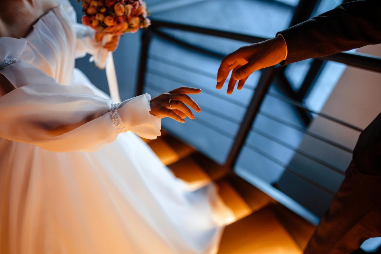Novotel Bishkek City Center Extérieur photo A bride and groom reach out to each other